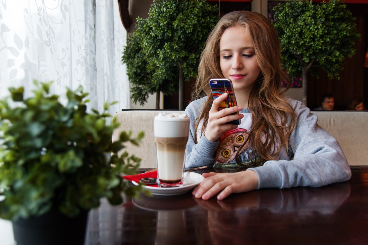 portrait-of-woman-photographing-with-smart-phone-248021